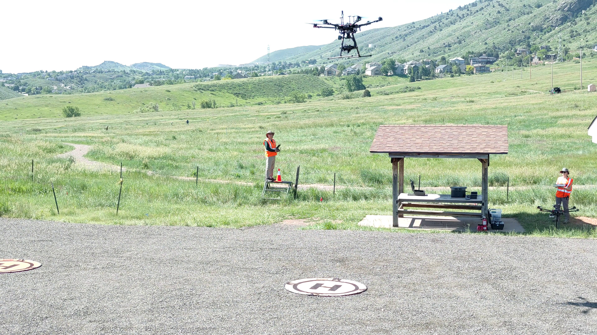 A drone and USGS field operators collecting data outdoors